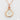 close up of charm on a dainty rose gold necklace, white moonstone charm necklace, dainty pink and white gemstone necklace 
